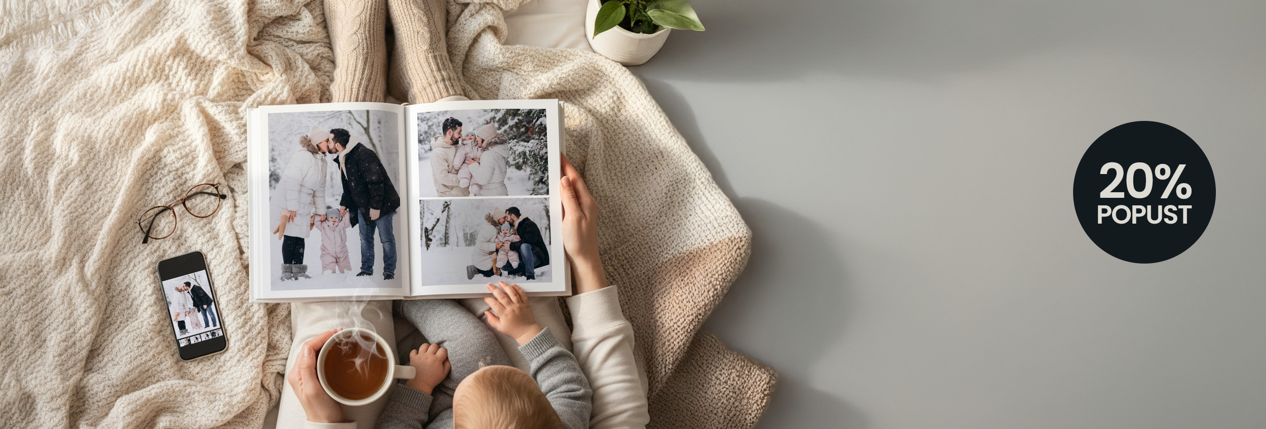 Family photo album in cozy winter setting with baby, tea, and smartphone, promoting photography services.