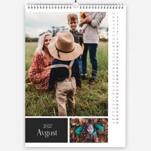 Family enjoying outdoor time in a grassy field with children and a woman in summer clothing.