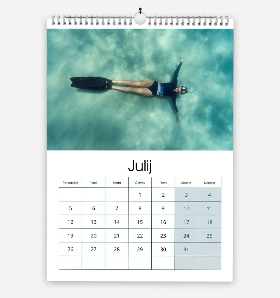 Calendar page for July with a person swimming underwater above it.