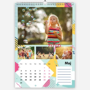 Colorful calendar with a young girl blowing bubbles outdoors in sunlight.