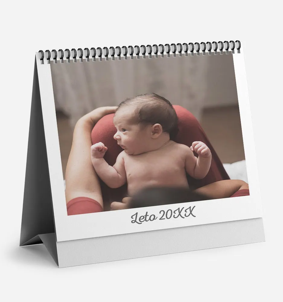 bela_dilema_0 Cute baby lying on a red cushion, looking to the side.