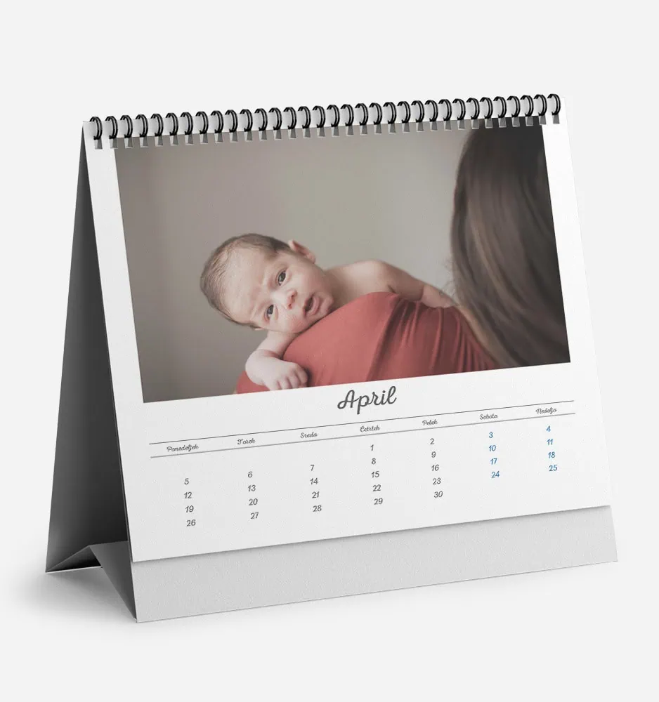 Baby lying on mother's shoulder in April calendar photo.