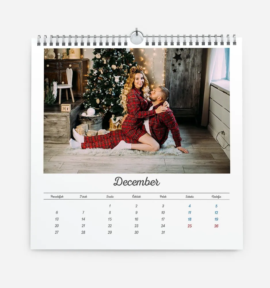 bela_dilema_4 Festive Christmas scene with a woman and child in front of decorated tree.