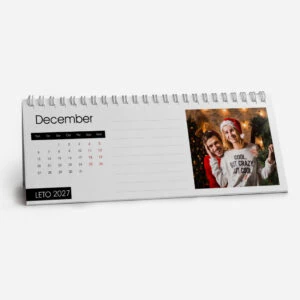 December 2023 desk calendar with a festive photo of two women in Christmas hats.