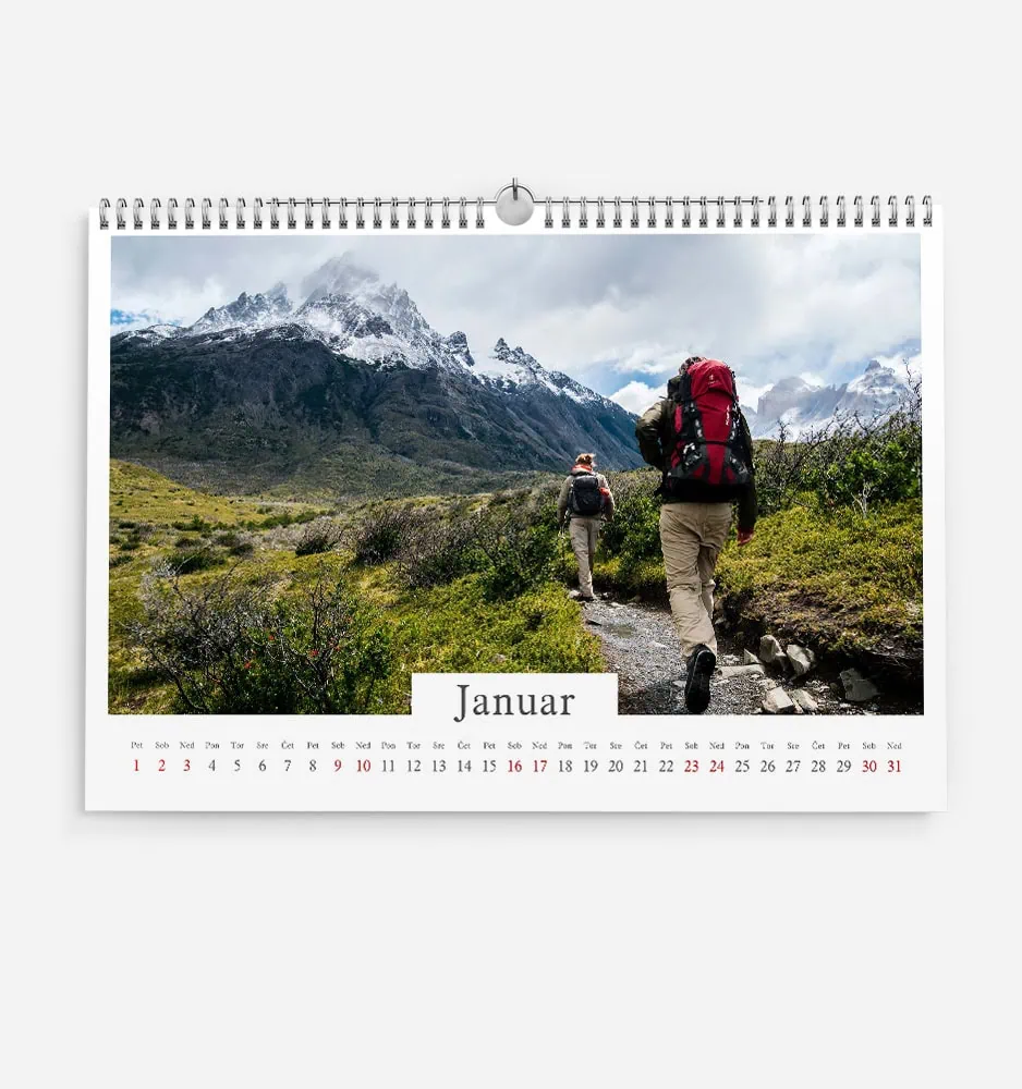 Hikers trekking through mountain landscape in January with snow-capped peaks.
