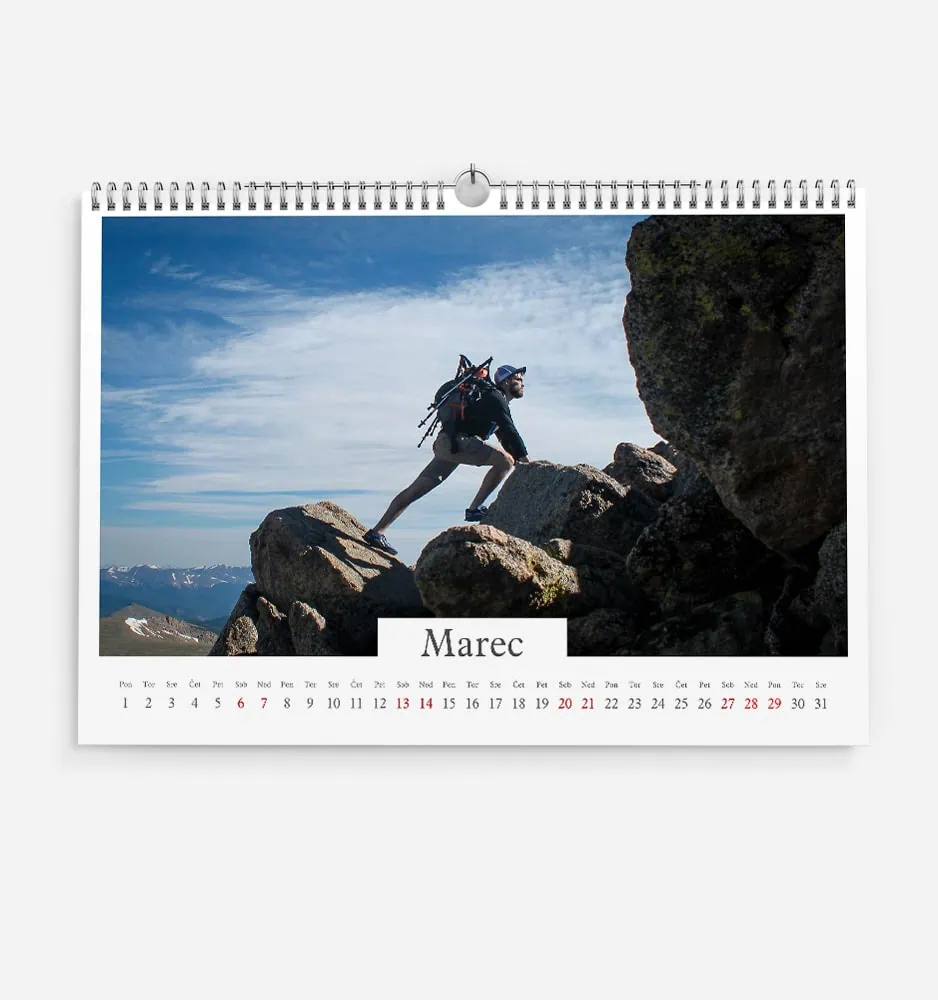 enojna_3 Hiker climbing rocky mountain terrain with backpack and helmet in daylight.
