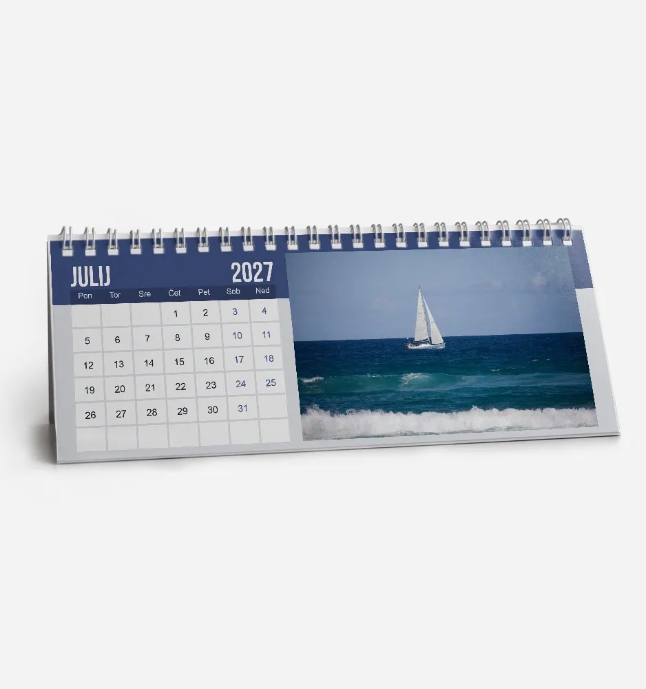 Desk calendar showing July 2027 with a sailboat on the ocean.