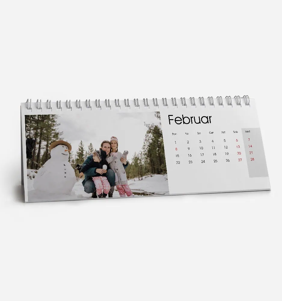 Family enjoying winter with snowman in a snowy landscape for February calendar.