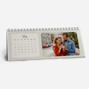 Personalized desk calendar with a photo of a smiling couple in a city setting.