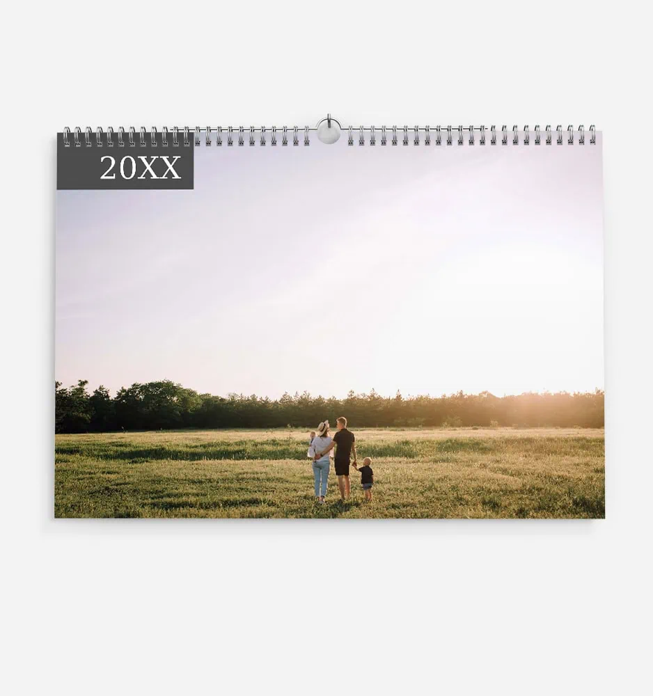 Family enjoying sunset in a green field with a calendar overlay.