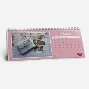 Pink February desk calendar with photos and gifts for Valentine's Day.