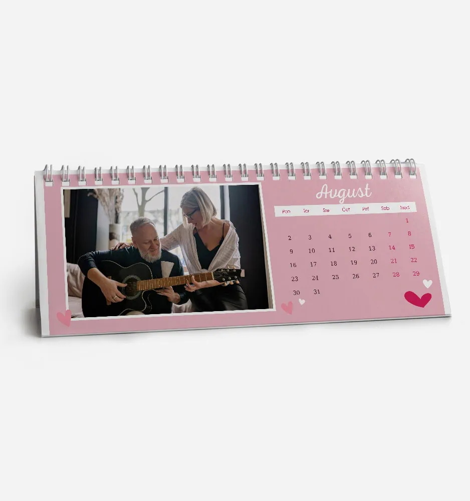 Pink August 2023 desk calendar with photo of a man playing guitar and a woman singing.