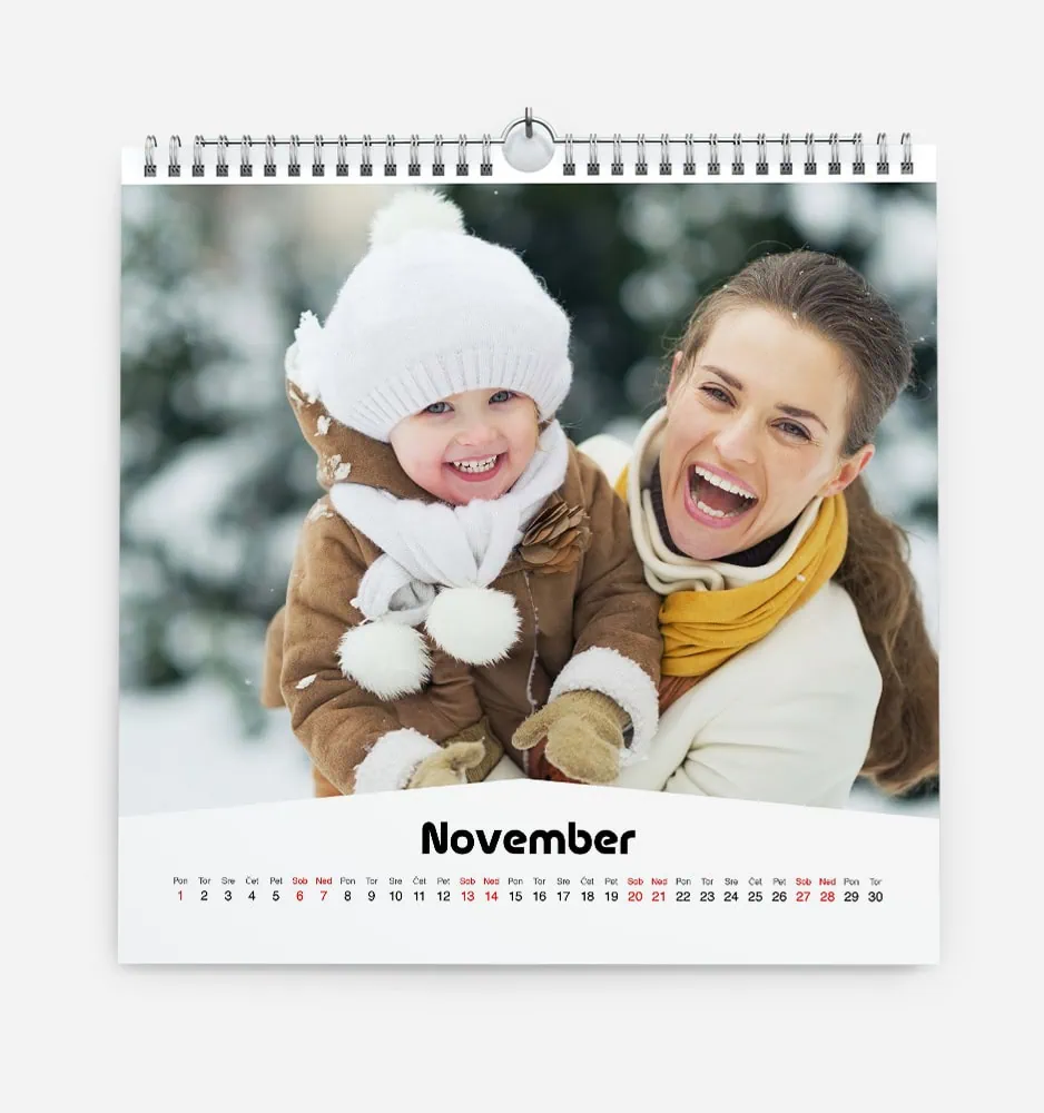 Joyful woman and child in winter clothing enjoying snowy outdoors.