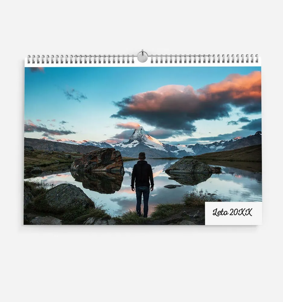 stolpec_1 Scenic mountain landscape with a person by a lake at sunset.