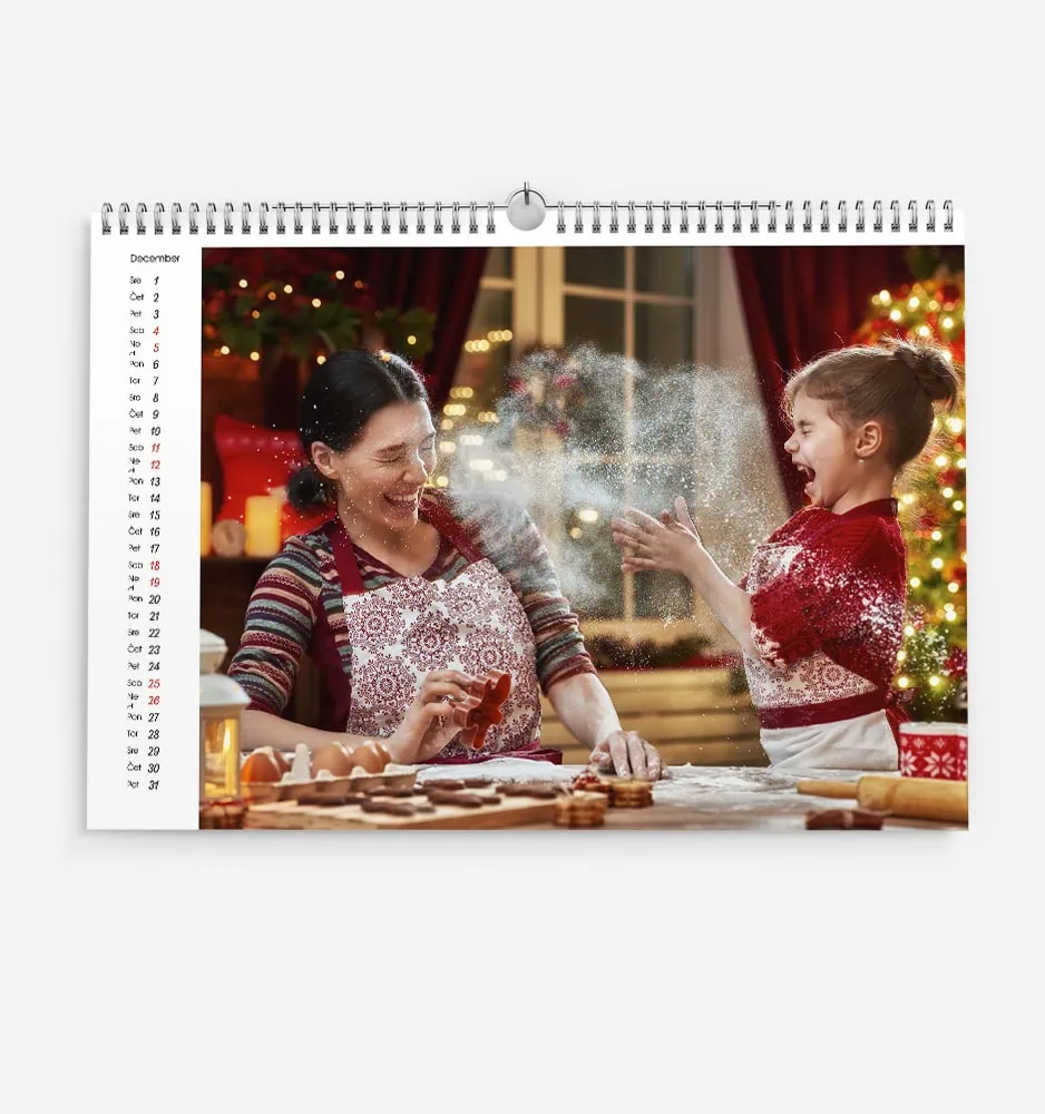 Joyful mother and daughter baking Christmas cookies together in festive home.