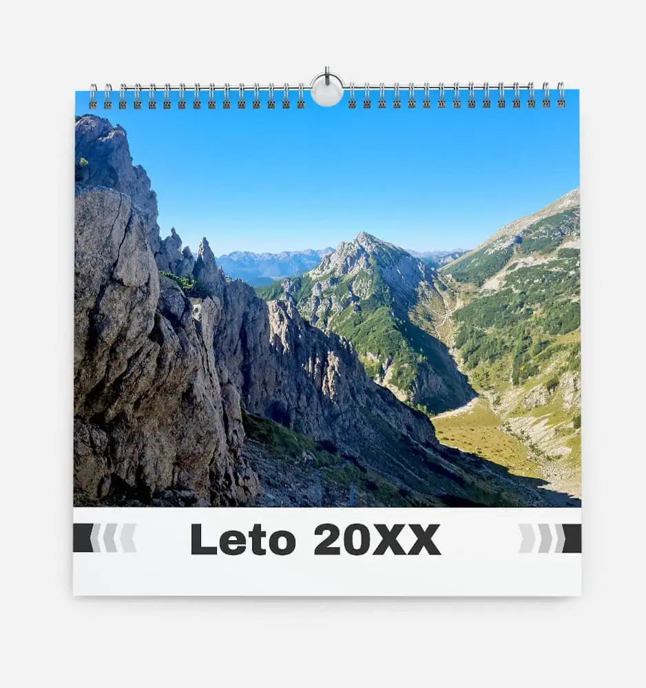 Scenic mountain landscape with rocky peaks and lush green valleys under a clear blue sky.