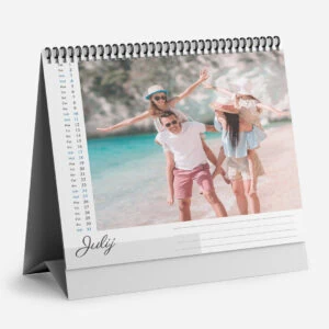 Family enjoying a beach day with kids and parents in summer hats and casual clothes.