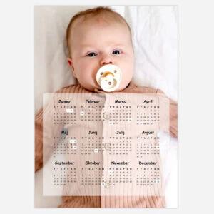 Baby with pacifier lying on bed with 2024 calendar overlay.