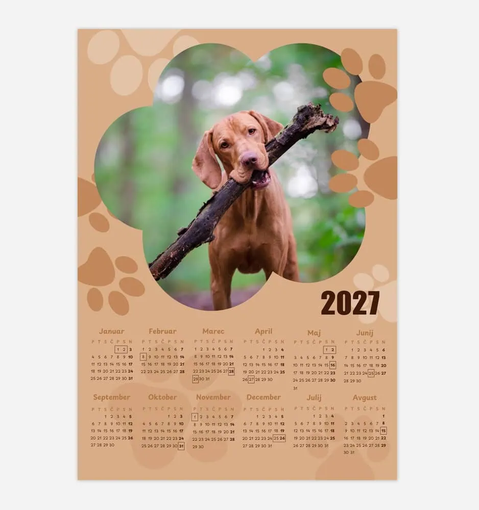 Cute brown puppy holding a stick in a green outdoor setting.