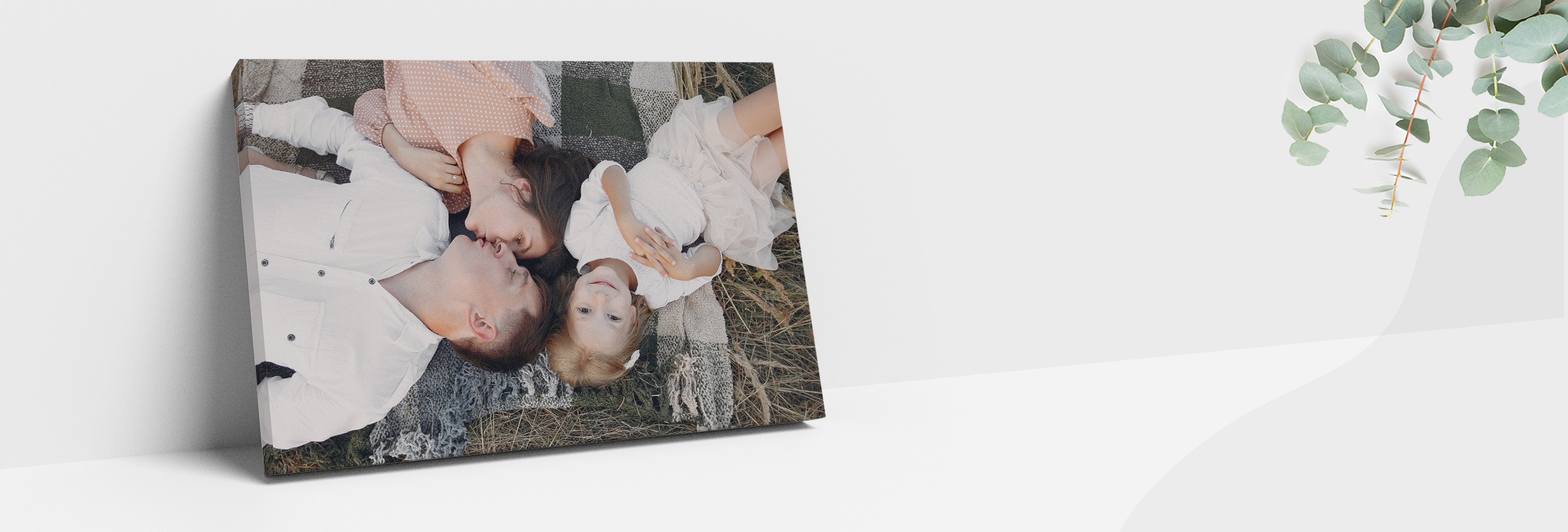 Family lying on the grass enjoying a sunny day outdoors.