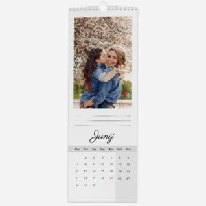 Springtime photo of a mother and daughter embracing under blooming cherry blossoms.