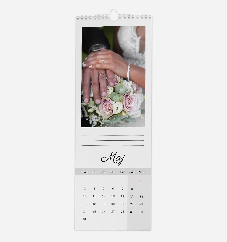 Close-up of wedding rings on bride and groom's hands with bouquet.